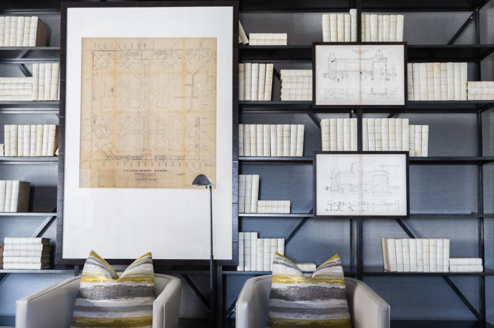 Single color bookshelves with maps and blueprints