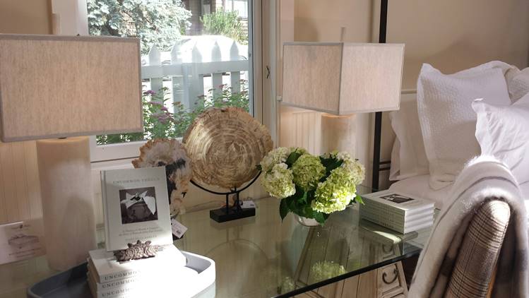 Uncommon Thread book displayed on a glass desk beneath a window