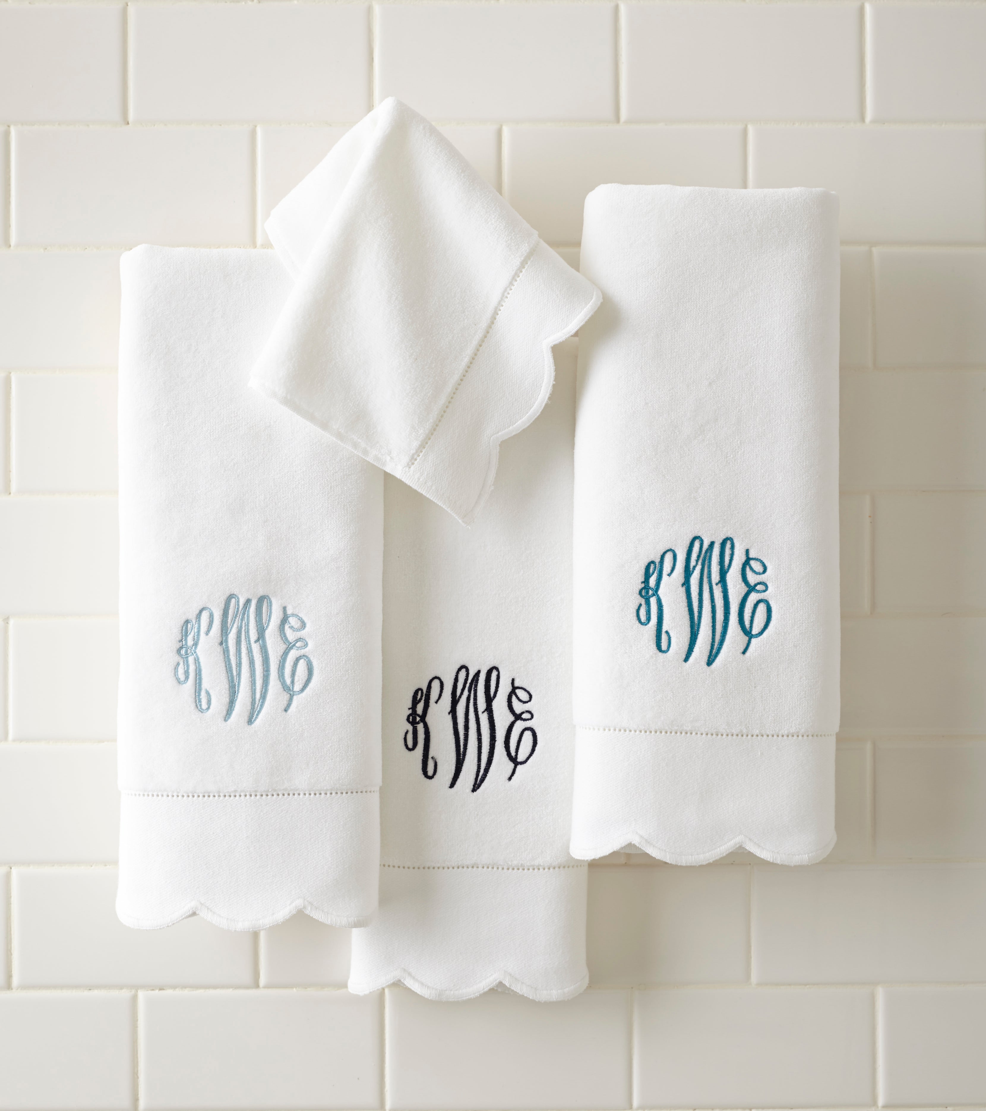 Monogrammed white towels with deep-scalloped dobby