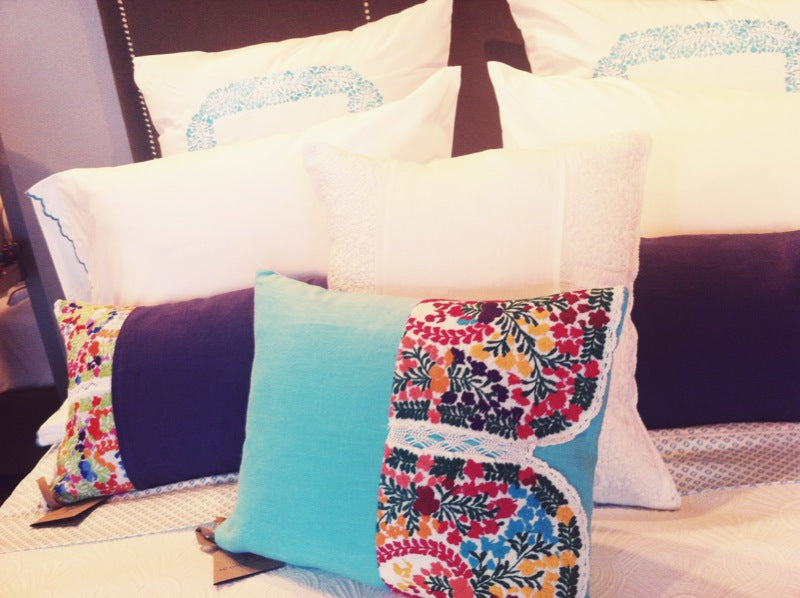 White and blue bedding accented with colorful Mexican floral fabrics