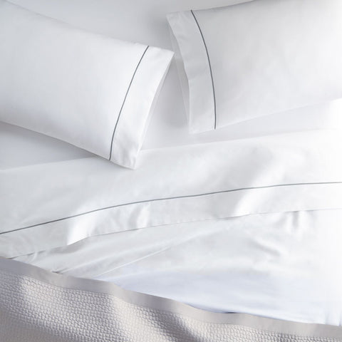 The luxury Boutique Percale Sheet Set with navy embroidery. | Peacock Alley