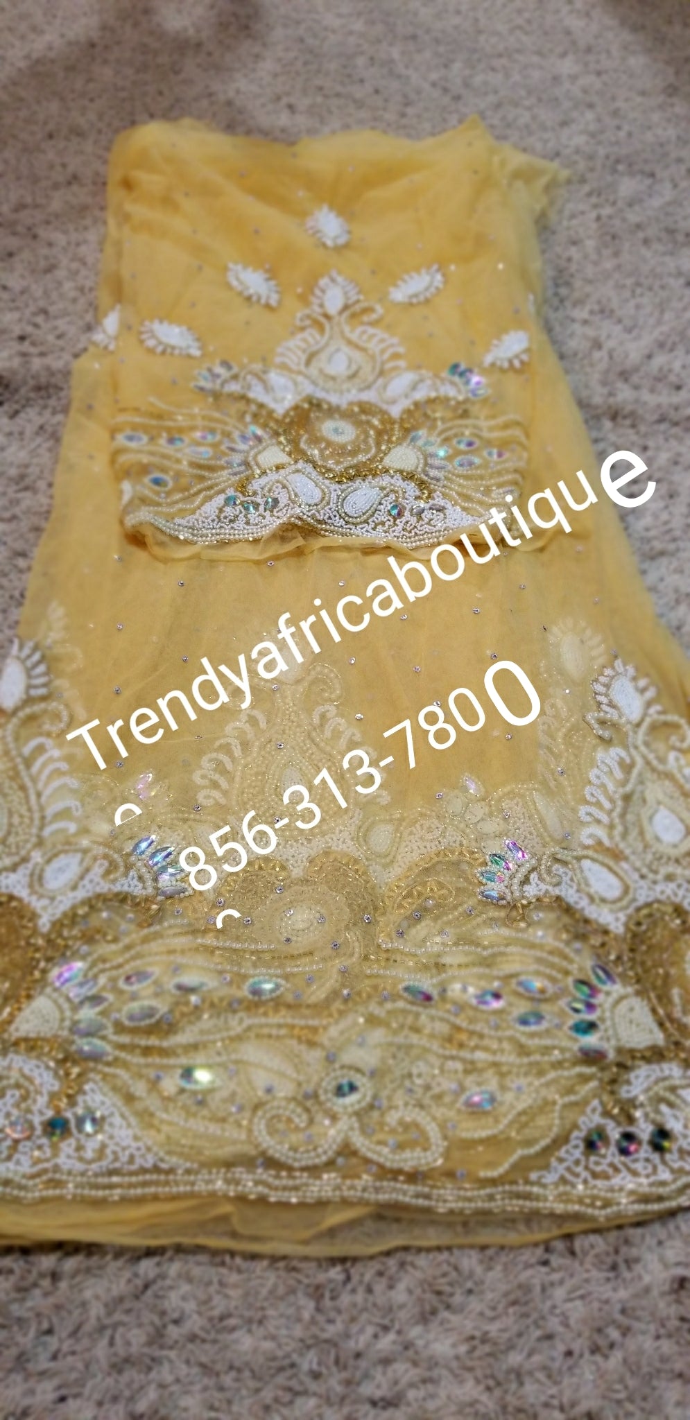 Heavily Beaded and hand stoned Net George fabric for Nigerian Ceremonies. Beautiful Gold color. Come 6.5yds fabric.