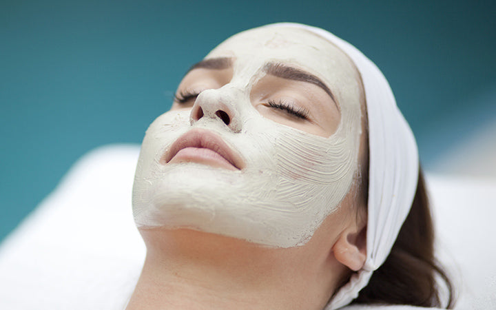 A young woman with a face pack.