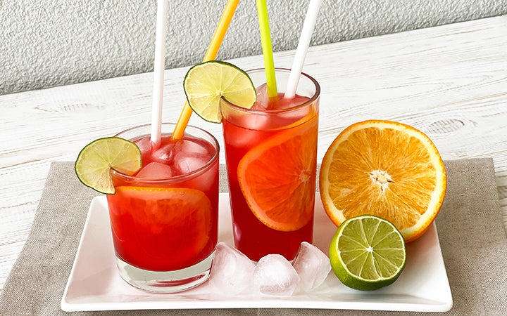 Cold juices in glasses with lime and ice