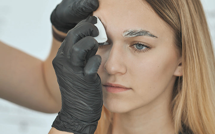 Woman getting removing bleach cream with a cotton