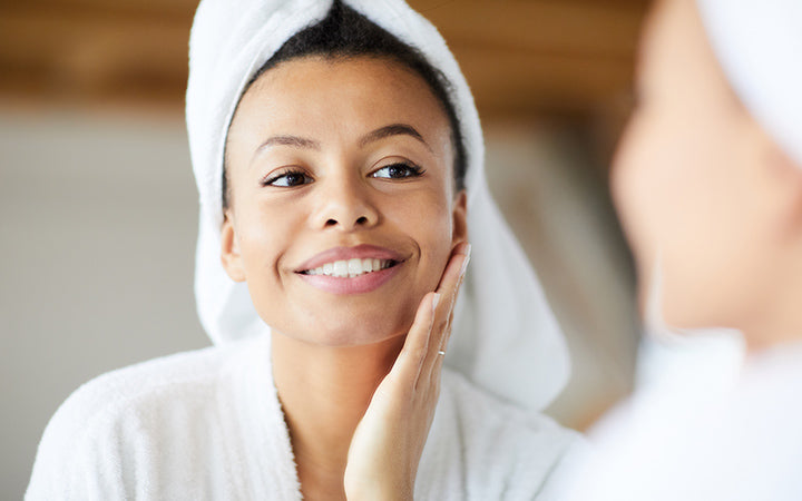 Woman looking in mirror during morning routine