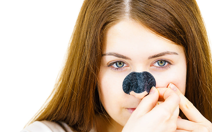 Woman removing pore cleansing textile mask