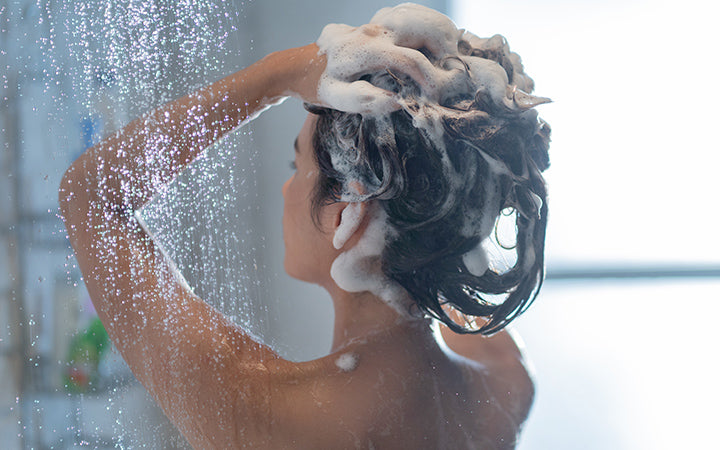 Woman washing hair and showering