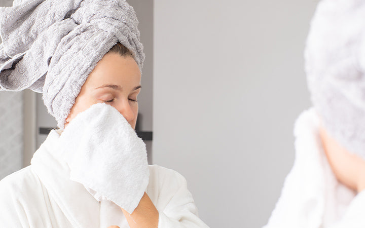 Woman with clean face and white towel