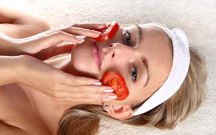 Woman with fresh tomatoes mask