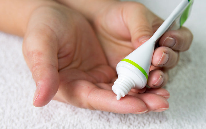 ointment on hand applying treatment hydration