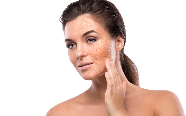 young beautiful woman with sugar scrub on her face