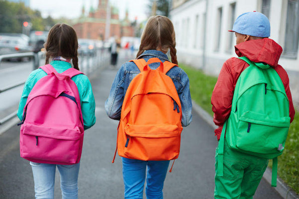 Kids walking with new colorful backpacks 