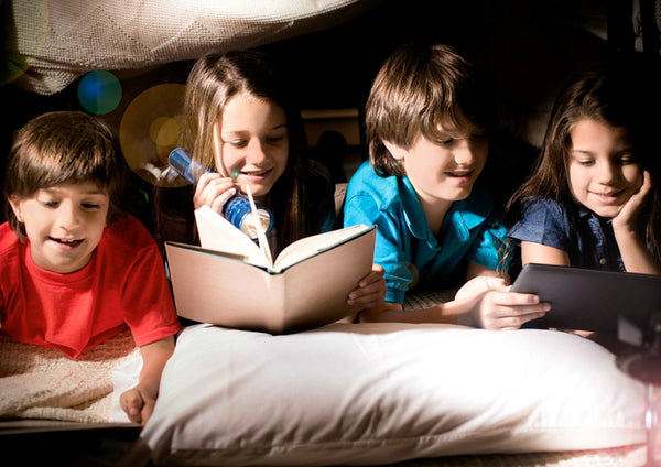 Kids in a pillow fort reading