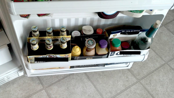 Using six packs as a way to organize the fridge's door.