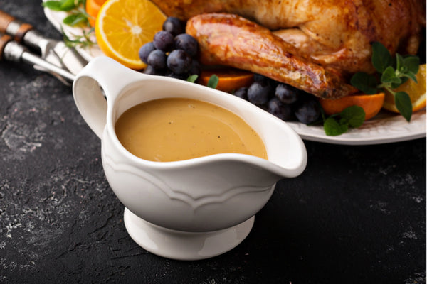 Homemade gravy in a sauce dish with turkey for Thanksgiving 