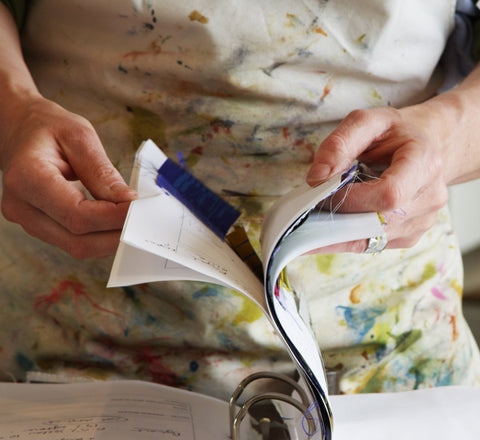 Jane Keith flicking through the dye book prior to mixing up colour