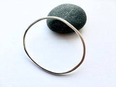 Organic shape silver bangle inspired by Henry Moore's sculptures by Michele Wyckoff Smith