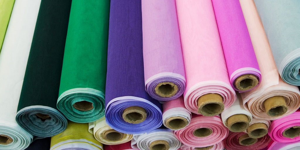 Various rolls of fabric at a bulk fabric stop Stock Photo