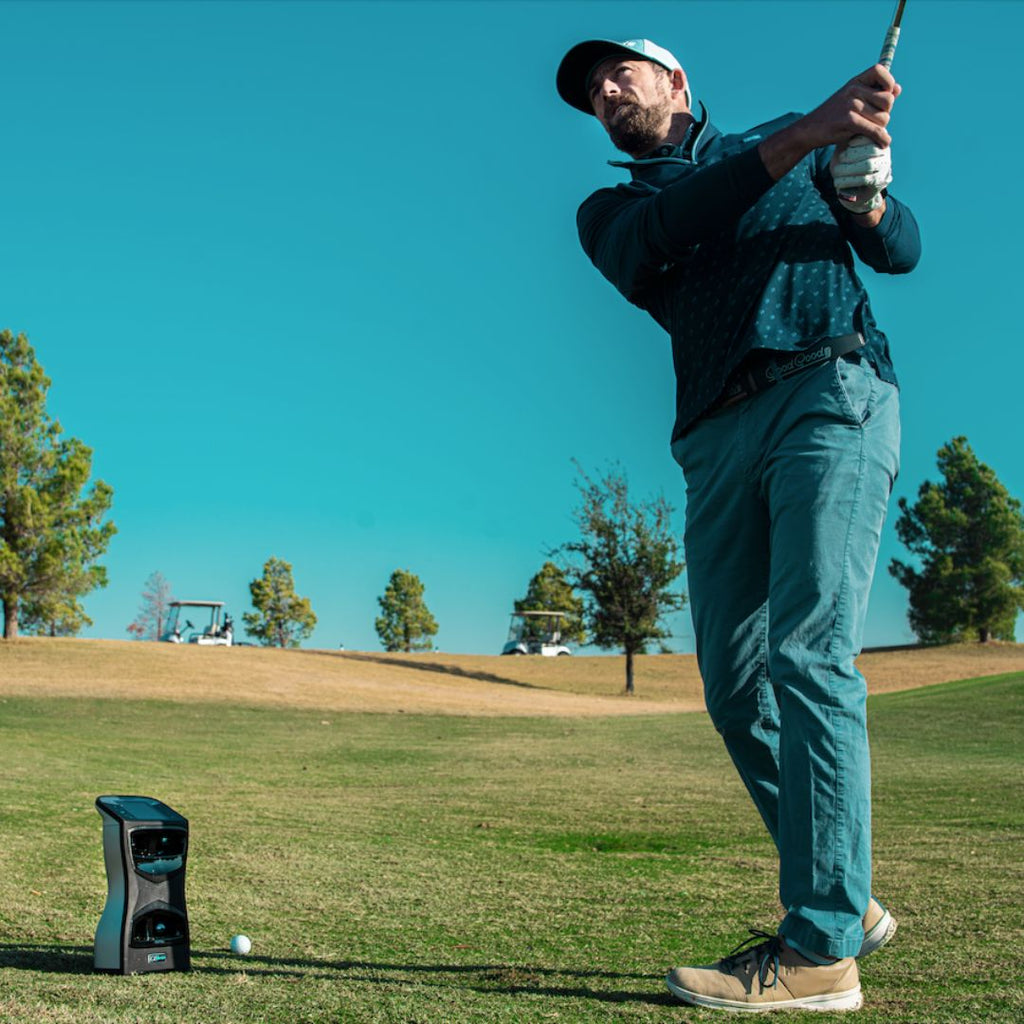 golfer hitting a golf shot after using the foresight gcquad on the course