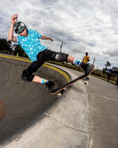 Tyler Dick skateboarding in a concrete bowl at a skatepark