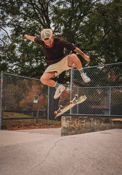 Skateboarder doing a flip trick at the skatepark
