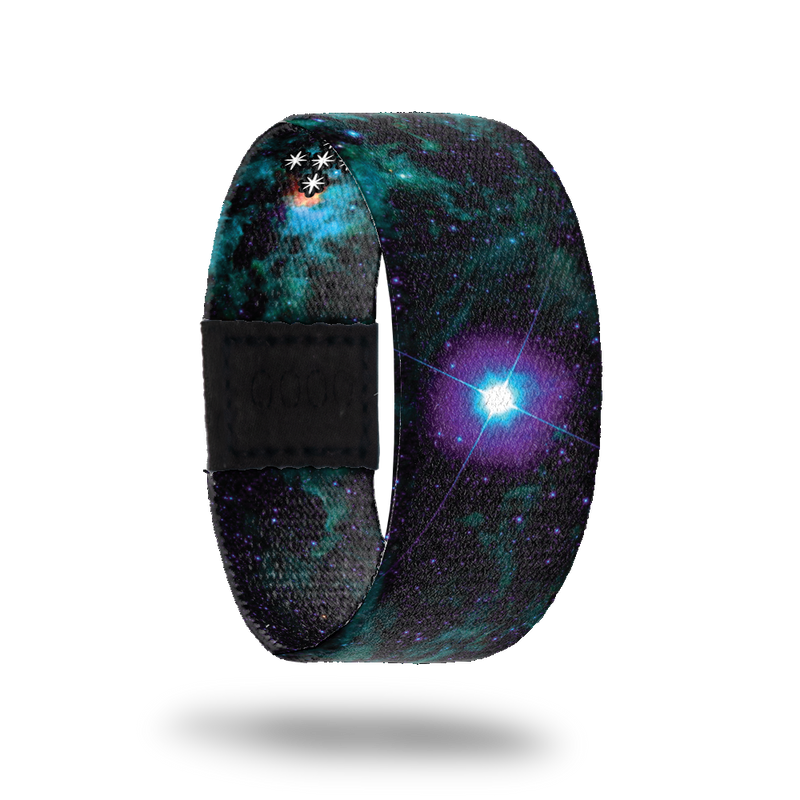 Dark black, green and blue galaxy image. Has one large spot of purple and blue like a bright star. Comes with a matching pin that is iridescent blue and purple. Can only be earned by collecting  100 white tickets.