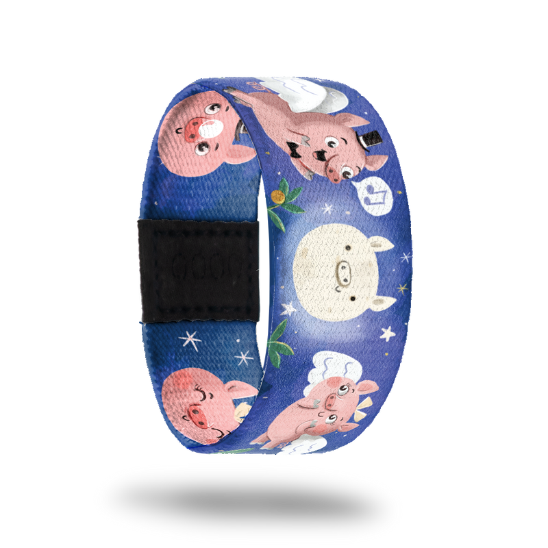 Blue strap with pigs flying with wings in the moonlight and singing. Inside is the same and says Anything Can Happen. Comes with matching lapel pin and collector's box. 