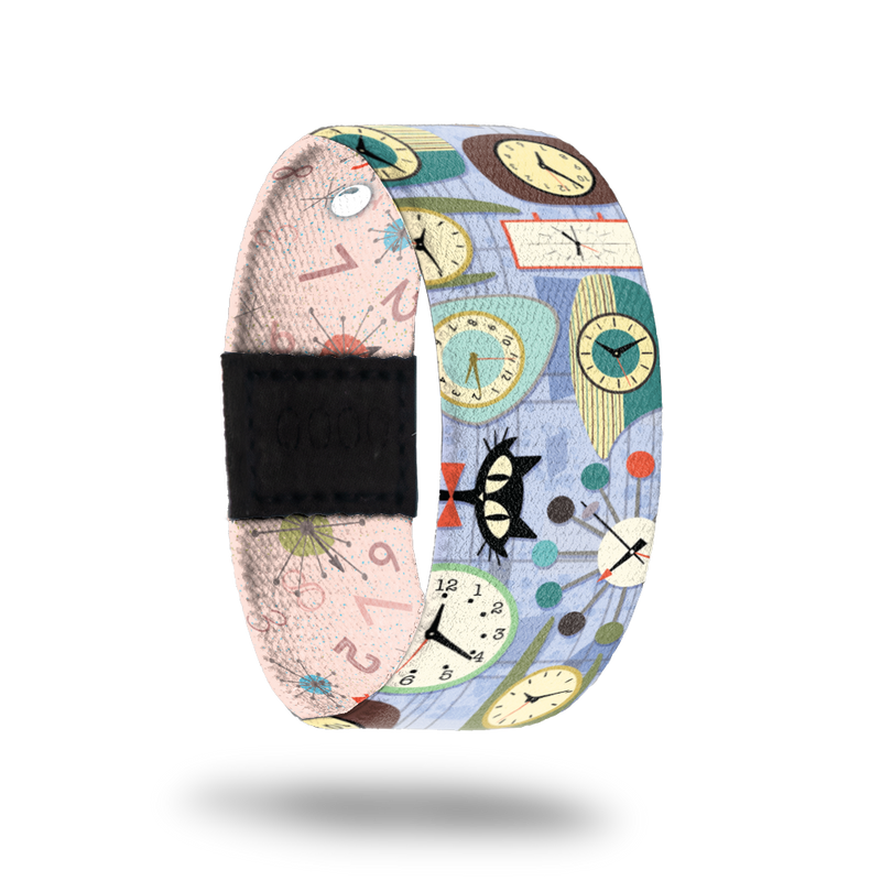 Pale blue strap with clocks and cats all over. Inside is pale pink with numbers and clocks all over and reads Better Late Than Never. Comes with a matching lapel pin and collector's box. 