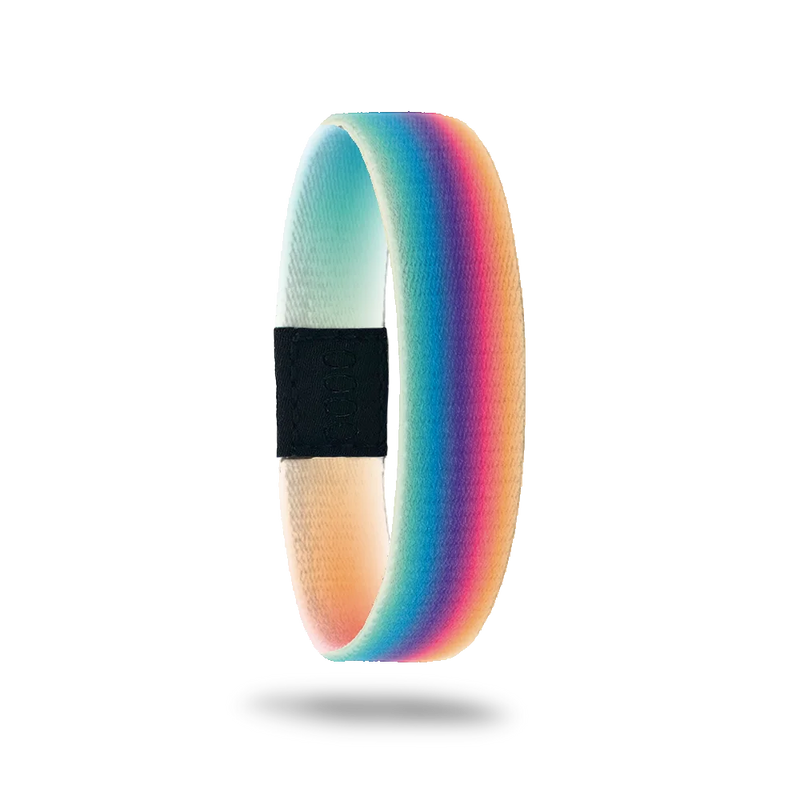 This is a reversible wristband. The design is a gradient rainbow that is blurred so the colors are more muted than primary colors. The inside is yellow and green gradient with the words Believe In Miracles. 