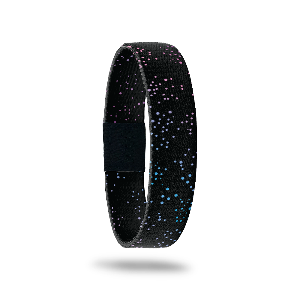 This is a reversible wristband. The design is black with gradient colored small dots all over. The inside is the same and says Collect The Happy Moments.