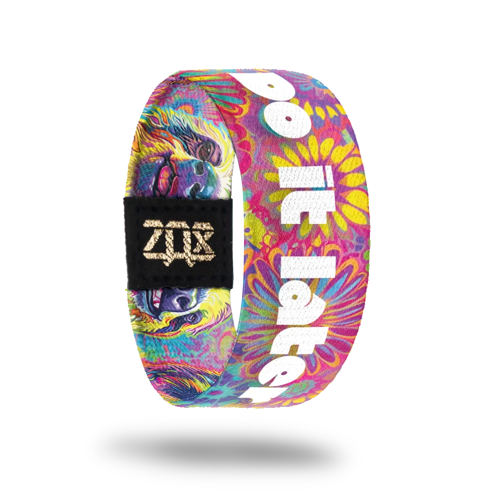 The inner side of the bracelet displays the same psychedelic illustrations of multicolored floral patterns. The background is a mix of pink, purple, blue, and yellow hues. Overlaid on this background is bold white text that reads, "Do it later," alongside more floral patterns. A black patch with a gold "ZOX" logo is also visible.