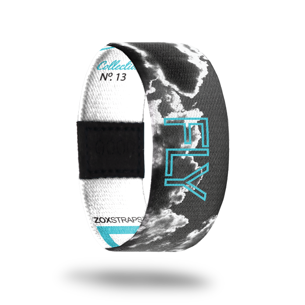 Dream.-Sold Out-ZOX - This item is sold out and will not be restocked. Outside Design Black and white cloud photograph with the sun reflecting off the clouds. There's a blue outline of the word 'FLY' going around the outside as well, to pay tribute to two of the biggest dreamers, Wilbur and Orville Wright. Inside Design White with blue 'Dream.' typography; vertical ZOXSTRAPS and Collection text with 'No. 13' under it all in blue. There are three blue lines on the inside as well.