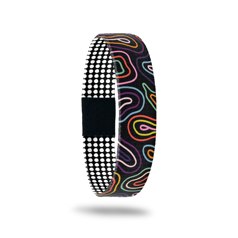ZOX single with black base and multicolored swirls on the outside. Inside is a black base with white symetrical dots and reads Expect the Unexpected. 