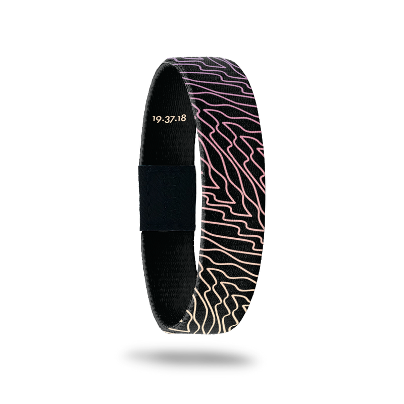 Wristband is black with gradient purple, pink and yellow swirls that are diagonal to the band.  Inside reads Forgiven.