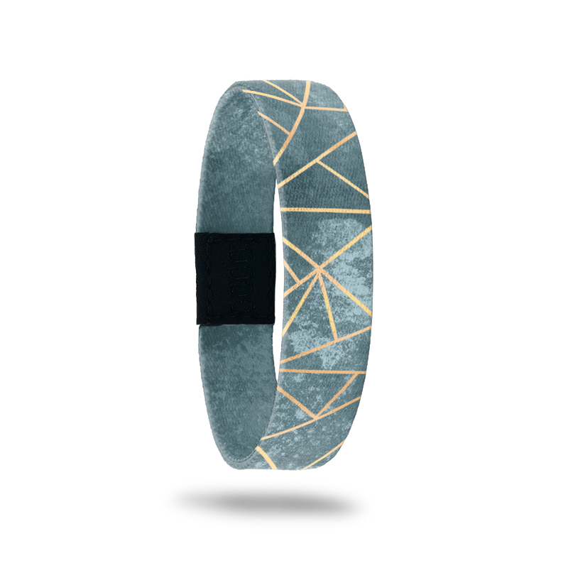 Wristband with muted green/teal marbled look and gold lines in a geometric pattern. Inside reads Greater Things To Come. 