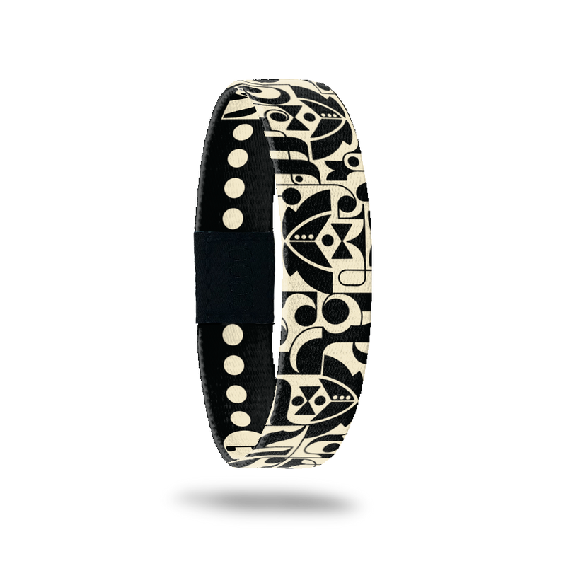 Wristband single with black base and geometric shapes that form tuxes, bowties and dress shirts. Inside reads Groom Crew. 