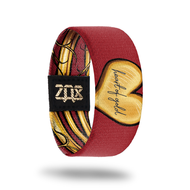 inside view of the heart of gold wristband. Dark red with gold heart shape, Heart of Gold text in the center. 