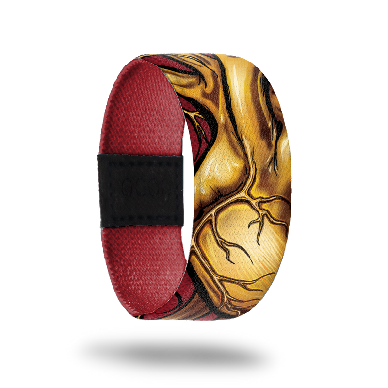 Dark red wristband with gold, lifelike heart drawing on outside.