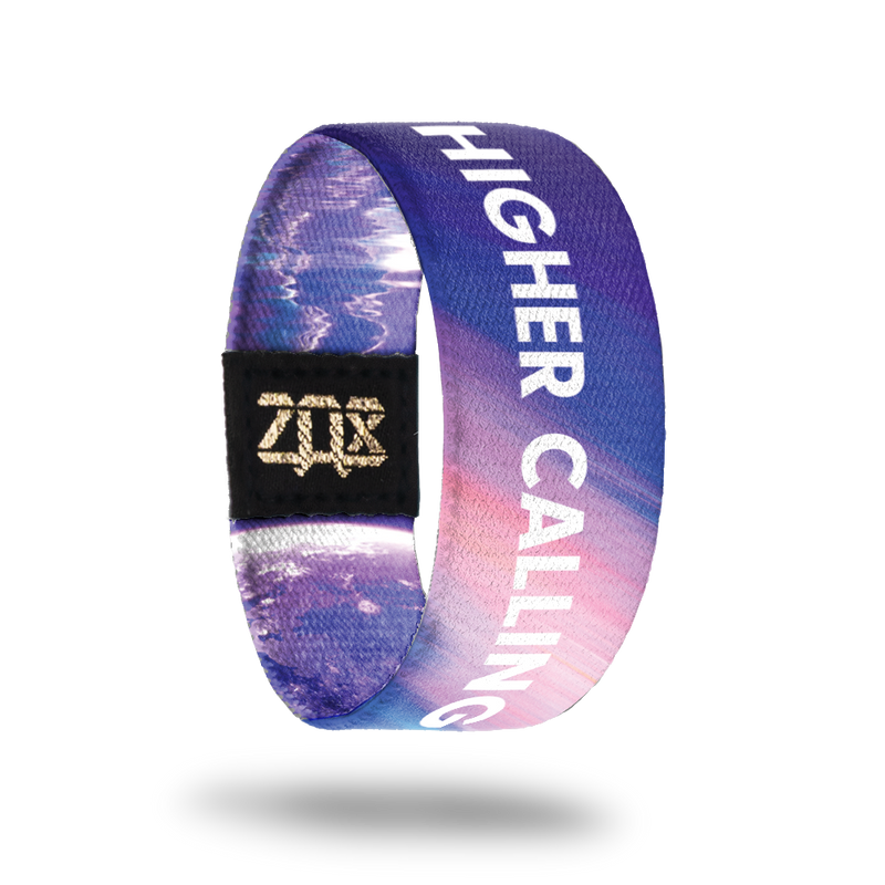 product image of the inside of a wristband named Higher Calling. It is mainly different hues of purple and is an astronaut in space on the outside of it