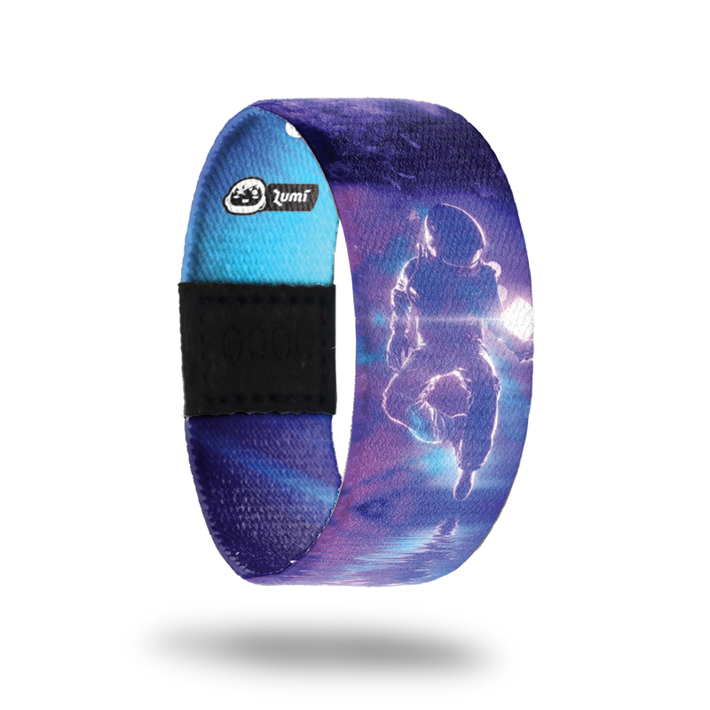 product image of the outside of a wristband named Higher Calling. It is mainly different hues of purple and is an astronaut in space