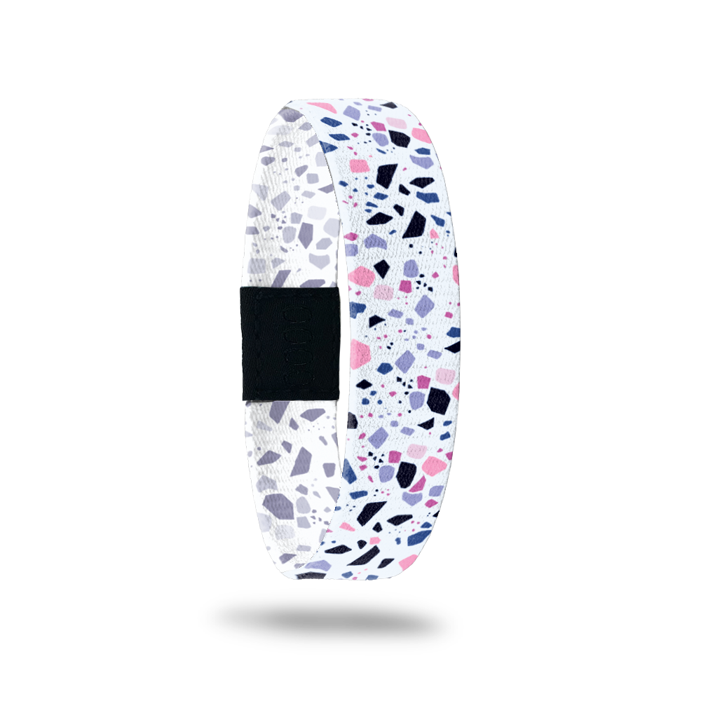 ristband single with a white base. The design is purple, pink, black and grey speckles all over. The inside is the same and reads Know Your Worth. 