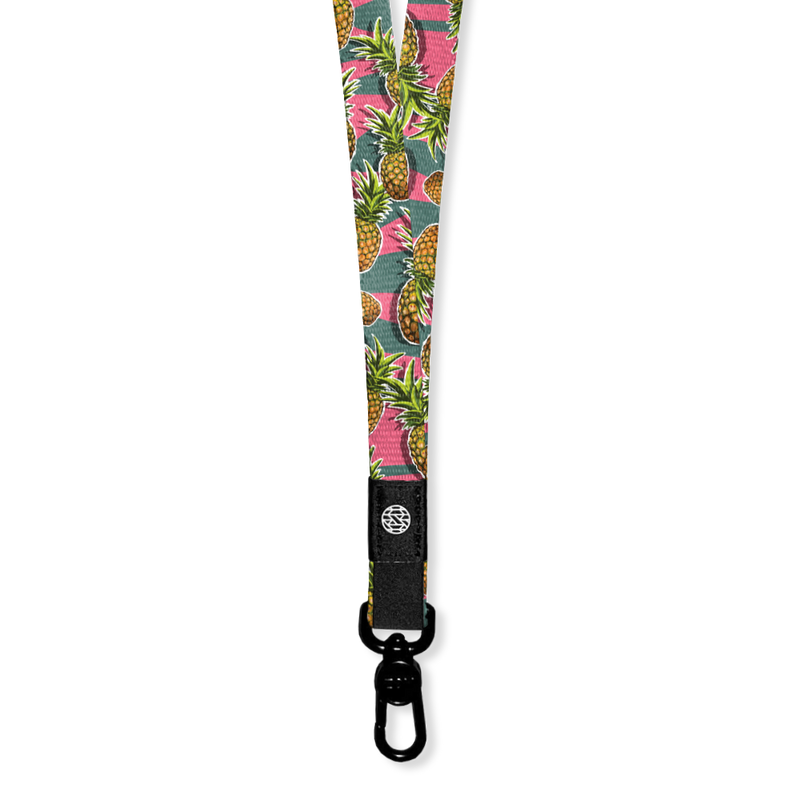 A lanyard with a green and pink horitzontal straip design. On top of the lines are pineapples all over and the inside reads Ohana. The lanyard has a metal pull-down clip but comes with two extra attachments to create a breakaway version too.