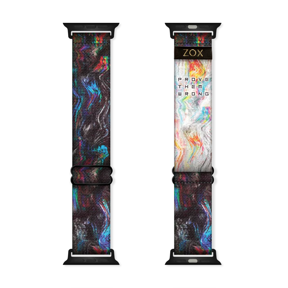 Watchband with all black and specs of multicolored swirls The inside is the same and reads Prove Them Wrong. . 