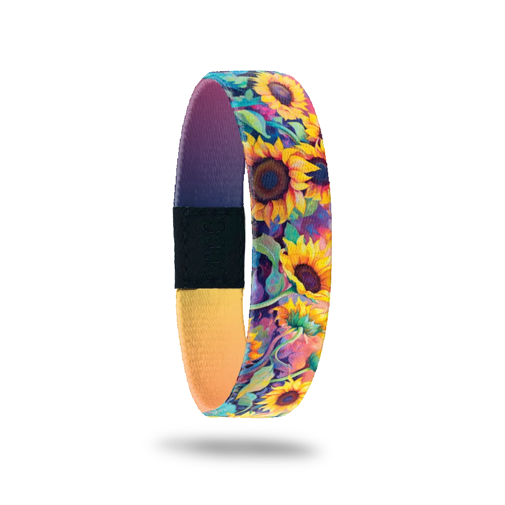 Wristband single with very bright and neon sunflowers with vines of blue, purple, pink. The inside is purple to yellow gradient and reads Radiate Positivity. 