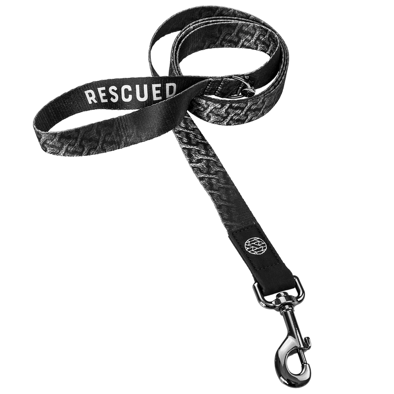 Dog leash with a black and white design of dog bones all over. The hoop handle reads Rescued. Comes with a metalpull-down hook. 