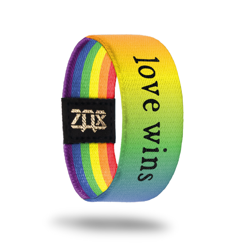 Inside Design of Love Wins: rainbow gradient with black text ‘Love Wins’ on strap