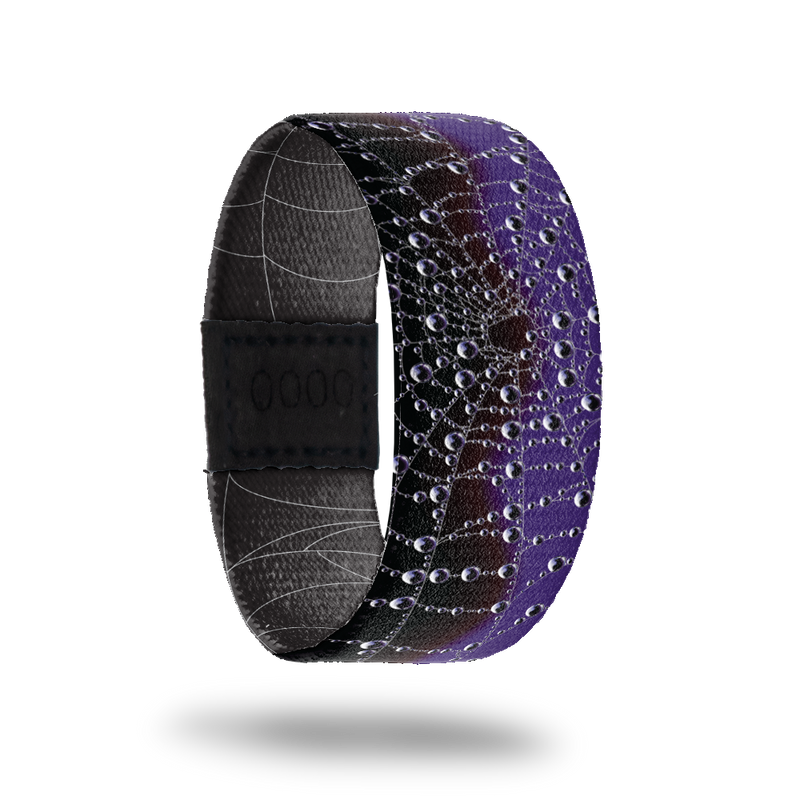 Wristband strap is black and purple with a spider web across the whole band. Comes with a matching purple and black spider lapel pin an collector's box. 