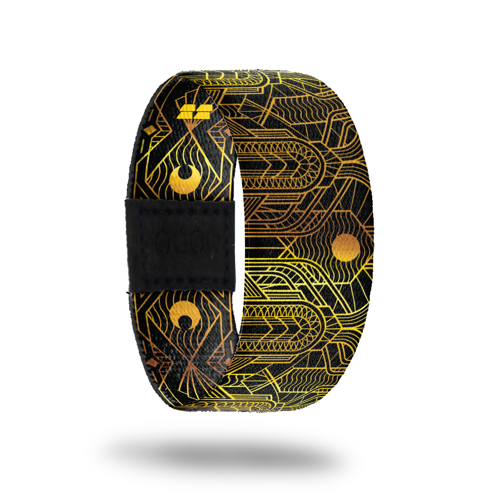 This is a reward, do not purchase. Black strap with gold lines all over in an abstract pattern. The inside is the same and reads Speak Easy. Comes with a matching lapel pin.  