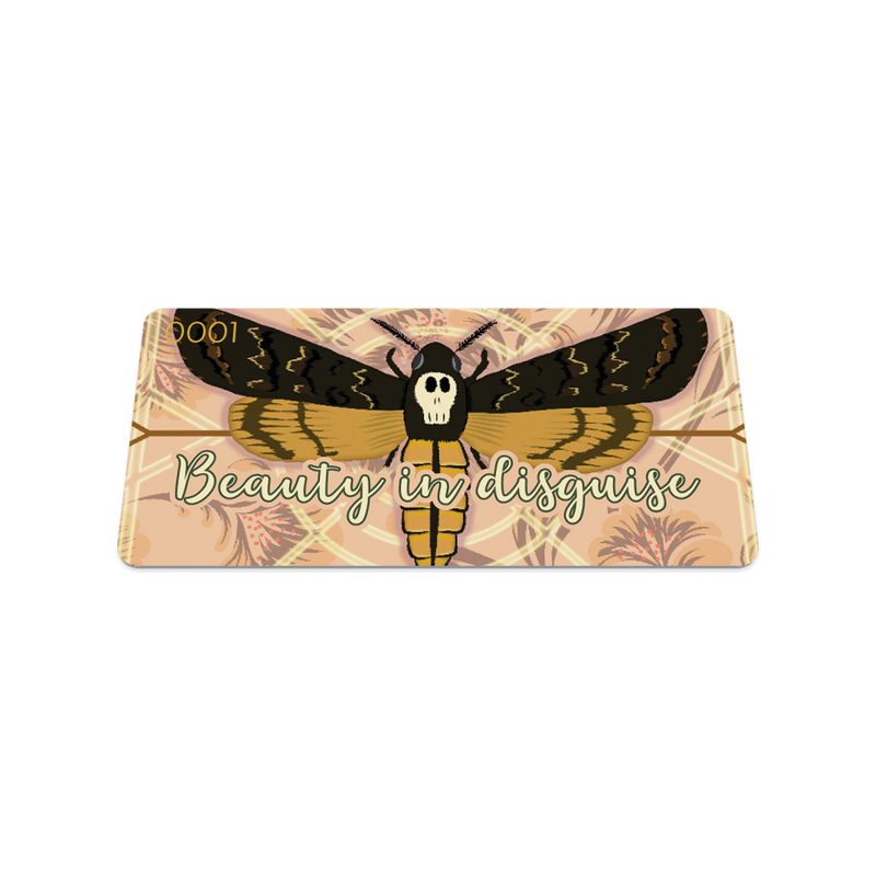 Front collector's card image of Beauty in Disguise, a tan design with cream and brown geometric details with a moth in the center